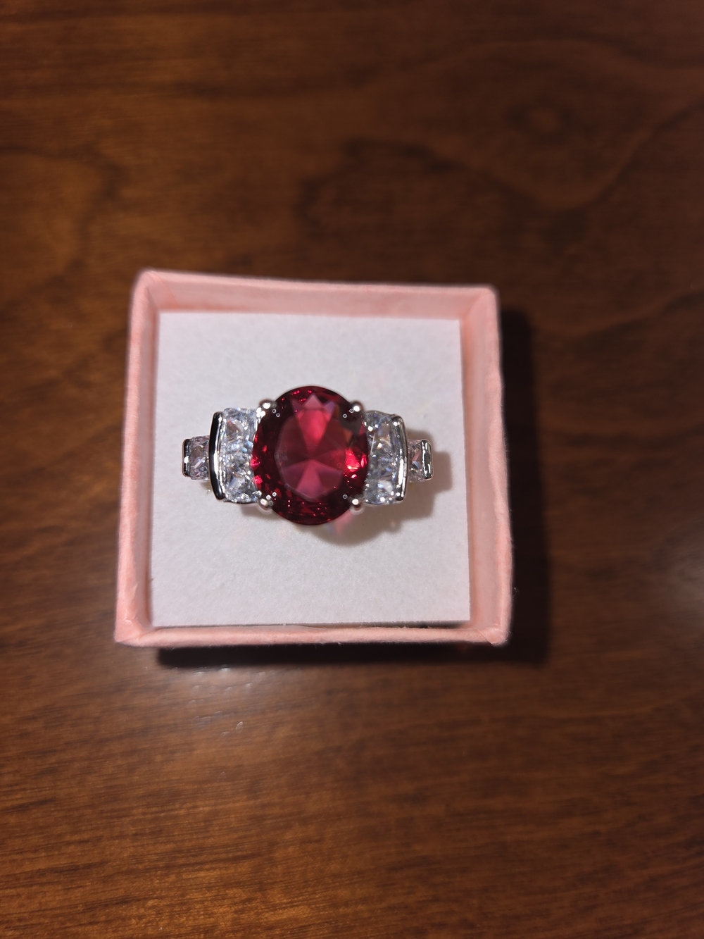 Elegant CZ Red Oval Gemstone Ring with Side Stones